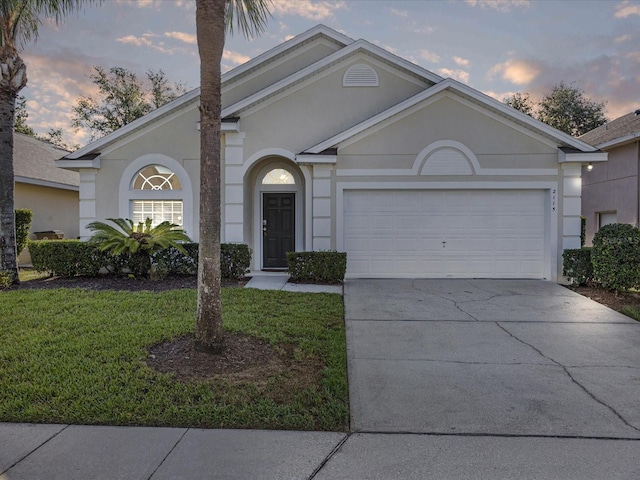 2115 Morning Star Dr, Clermont, FL 34714 - view of front of house with driveway, an attached garage, a front yard, and stucco siding