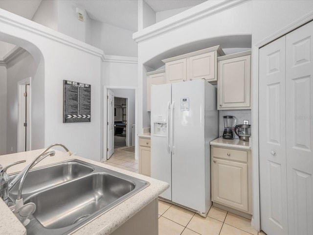 2115 Morning Star Dr, Clermont, FL 34714 - kitchen featuring white refrigerator with ice dispenser, a sink, light tile patterned flooring, light countertops, and arched walkways