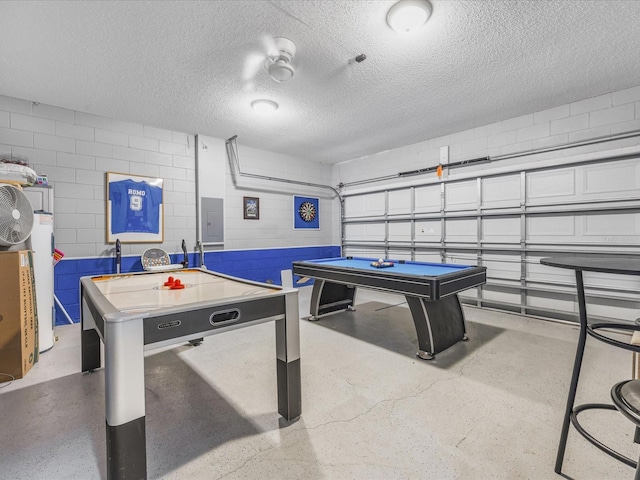 2115 Morning Star Dr, Clermont, FL 34714 - playroom with electric panel, concrete block wall, a garage, concrete flooring, and a textured ceiling