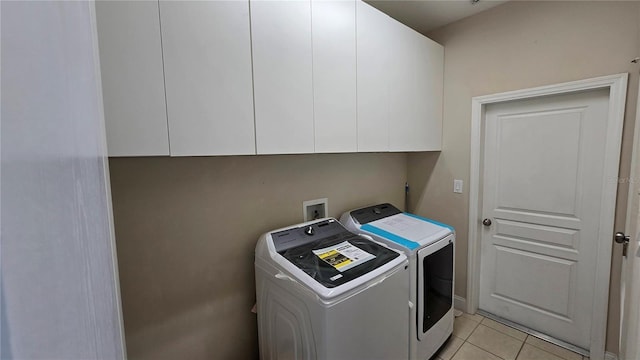 12126 Diedra Ct, Orlando, FL 32825 - washroom featuring washer and clothes dryer, cabinet space, and light tile patterned floors