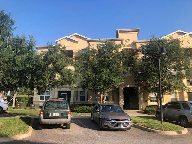 obstructed view of property with uncovered parking