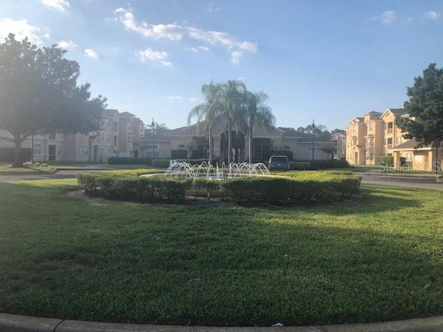 view of home's community featuring a lawn and a residential view