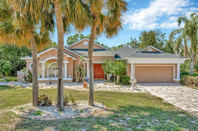 14680 Linden Dr, Spring Hill, FL 34609 - view of front of home with a front lawn, stucco siding, a garage, and decorative driveway