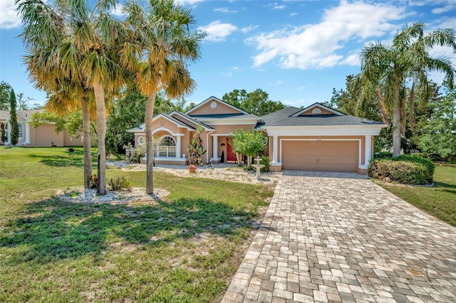 14680 Linden Dr, Spring Hill, FL 34609 - view of front facade with an attached garage, decorative driveway, a front lawn, and stucco siding