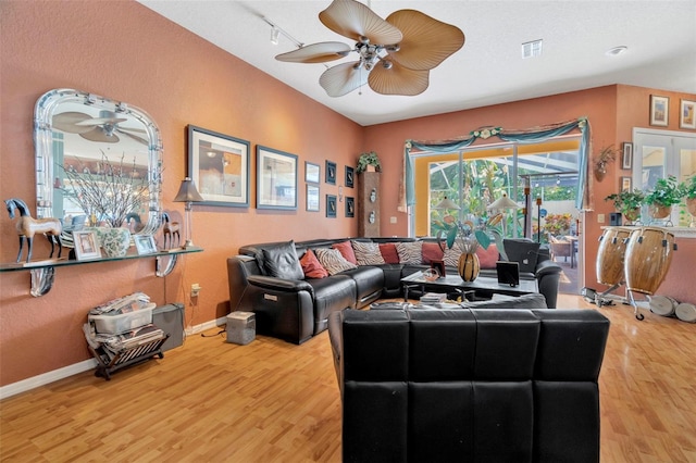 14680 Linden Dr, Spring Hill, FL 34609 - living room featuring ceiling fan, wood finished floors, and baseboards