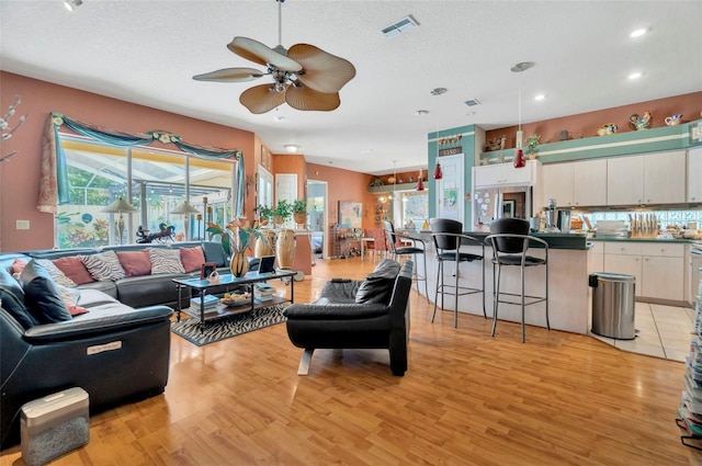 14680 Linden Dr, Spring Hill, FL 34609 - living room with a ceiling fan, plenty of natural light, light wood-type flooring, recessed lighting, and a textured ceiling