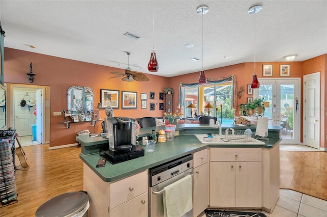 14680 Linden Dr, Spring Hill, FL 34609 - kitchen featuring dishwasher, a ceiling fan, a textured ceiling, a kitchen island with sink, and pendant lighting