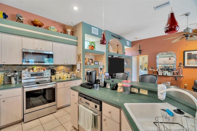 14680 Linden Dr, Spring Hill, FL 34609 - kitchen with stainless steel appliances, backsplash, a sink, light tile patterned floors, and dark countertops