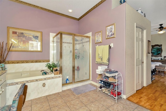 14680 Linden Dr, Spring Hill, FL 34609 - bathroom with ornamental molding, a stall shower, a ceiling fan, a bath, and connected bathroom