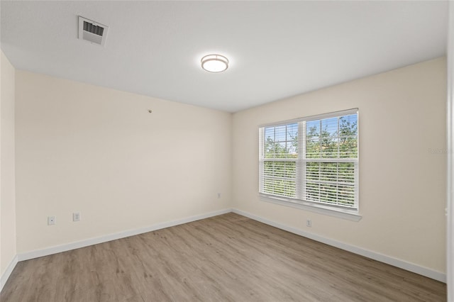 5447 Vineland Rd Unit 1308, Orlando, FL 32811 - unfurnished room with light wood-style floors and baseboards