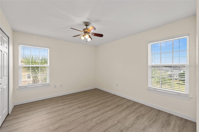 5447 Vineland Rd Unit 1308, Orlando, FL 32811 - unfurnished bedroom with light wood finished floors, baseboards, and a closet
