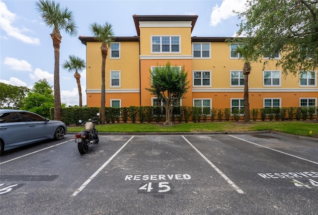 5447 Vineland Rd Unit 1308, Orlando, FL 32811 - view of building exterior featuring uncovered parking