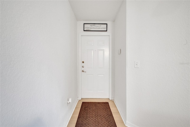 entryway featuring light wood-style floors and baseboards