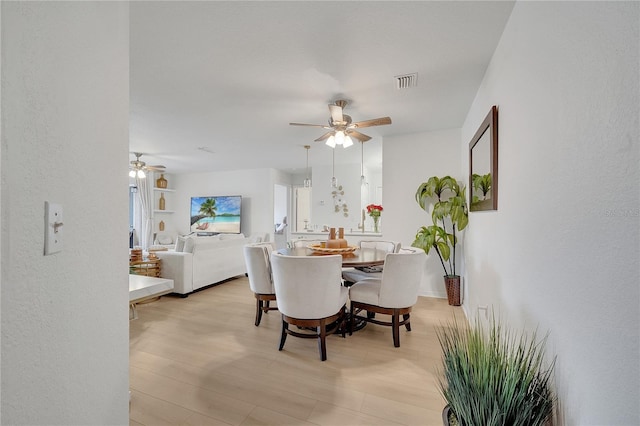 dining room featuring ceiling fan and light wood-type flooring