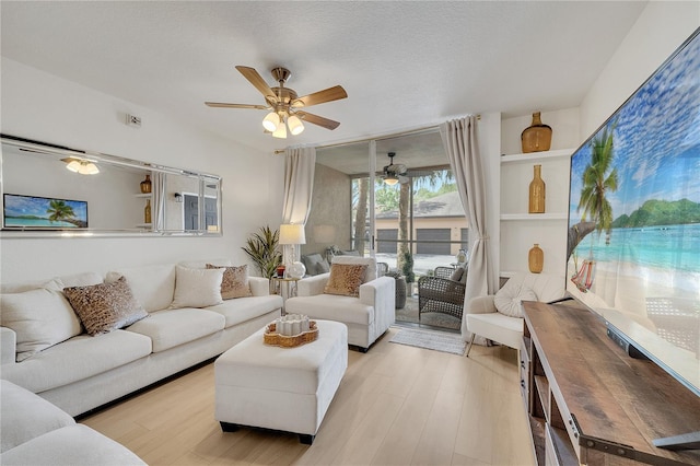living area with ceiling fan and wood finished floors