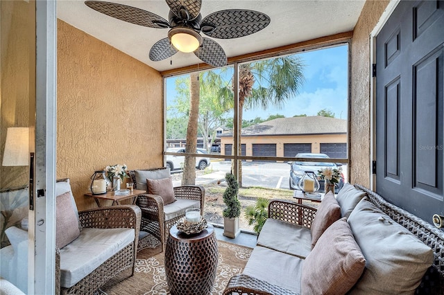 sunroom with a ceiling fan and outdoor lounge area