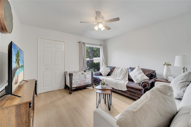 living area with a ceiling fan and light wood-style floors