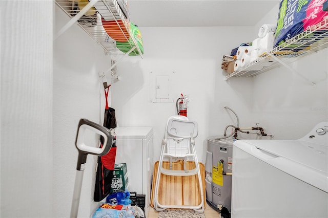 clothes washing area featuring separate washer and dryer and water heater