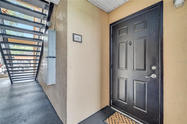 entrance to property with stucco siding