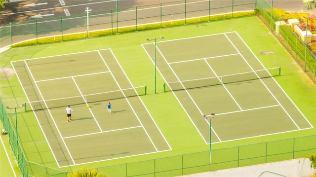 view of tennis court featuring fence
