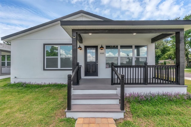 1050 20th St, Orlando, FL 32805 - view of front facade featuring a front lawn and stucco siding