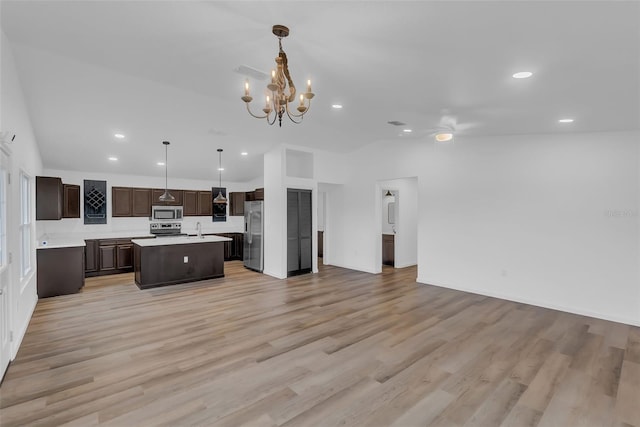 1050 20th St, Orlando, FL 32805 - kitchen featuring open floor plan, stainless steel appliances, dark brown cabinetry, a sink, and light countertops