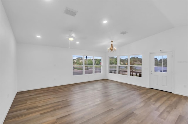 1050 20th St, Orlando, FL 32805 - unfurnished room with a chandelier, wood finished floors, baseboards, recessed lighting, and vaulted ceiling