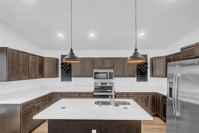1050 20th St, Orlando, FL 32805 - kitchen featuring stainless steel appliances, a sink, light countertops, dark brown cabinetry, and recessed lighting