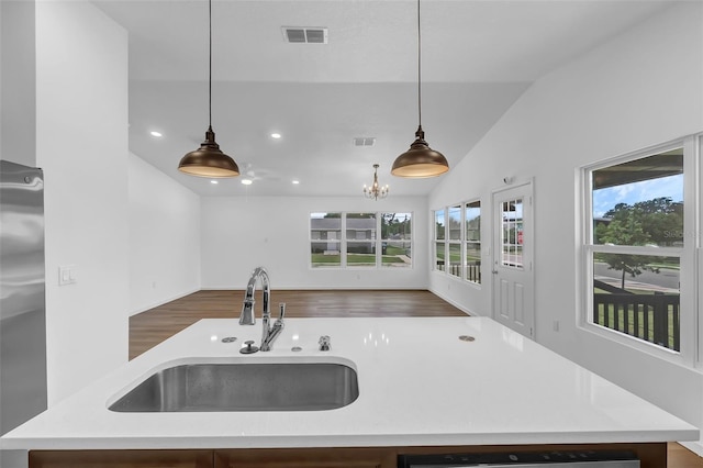 1050 20th St, Orlando, FL 32805 - kitchen with a sink, lofted ceiling, open floor plan, stainless steel fridge, and light countertops
