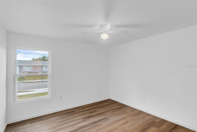 1050 20th St, Orlando, FL 32805 - spare room featuring wood finished floors, ceiling fan, and baseboards