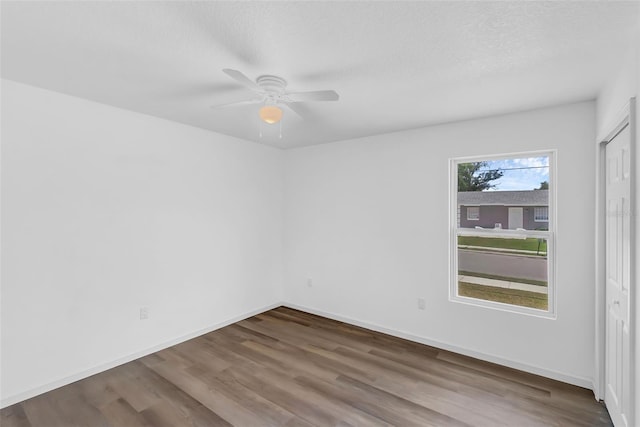 1050 20th St, Orlando, FL 32805 - spare room featuring wood finished floors, a ceiling fan, and baseboards