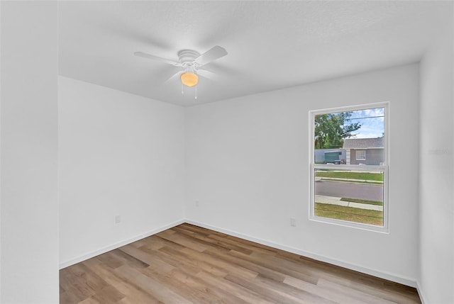 1050 20th St, Orlando, FL 32805 - unfurnished room with wood finished floors, ceiling fan, and baseboards