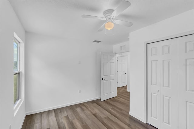 1050 20th St, Orlando, FL 32805 - unfurnished bedroom with wood finished floors, baseboards, a closet, and ceiling fan