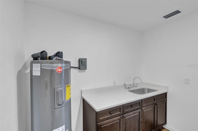 1050 20th St, Orlando, FL 32805 - washroom with electric water heater and a sink