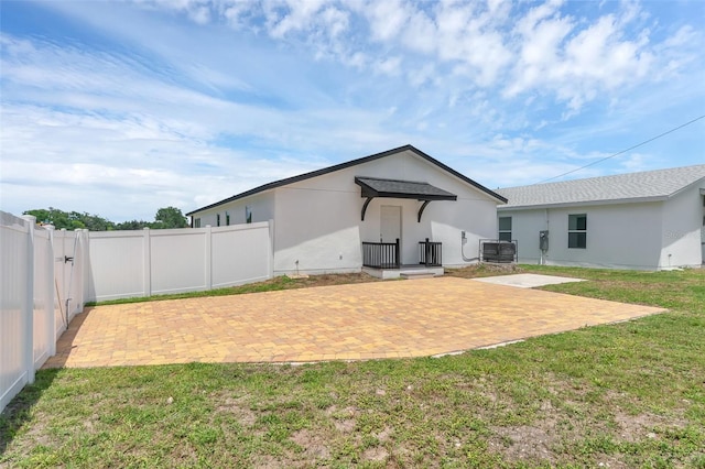 1050 20th St, Orlando, FL 32805 - rear view of house with central AC unit, a patio, and stucco siding