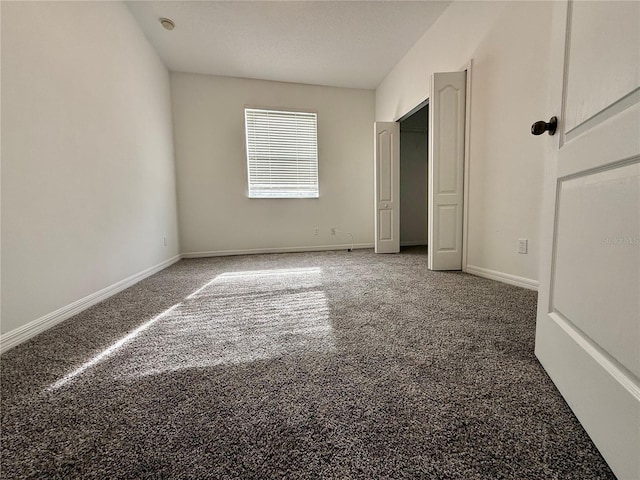 unfurnished bedroom with carpet floors and baseboards