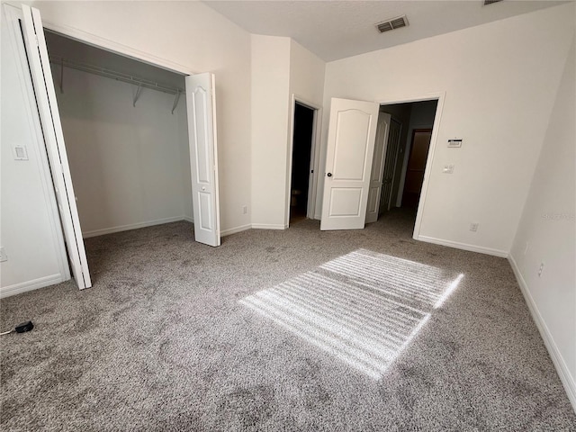 unfurnished bedroom featuring carpet, baseboards, and a closet