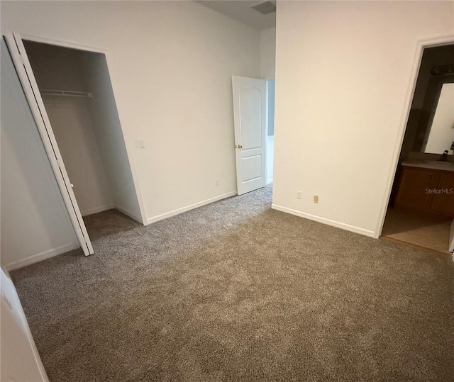unfurnished bedroom featuring carpet flooring, a closet, and baseboards
