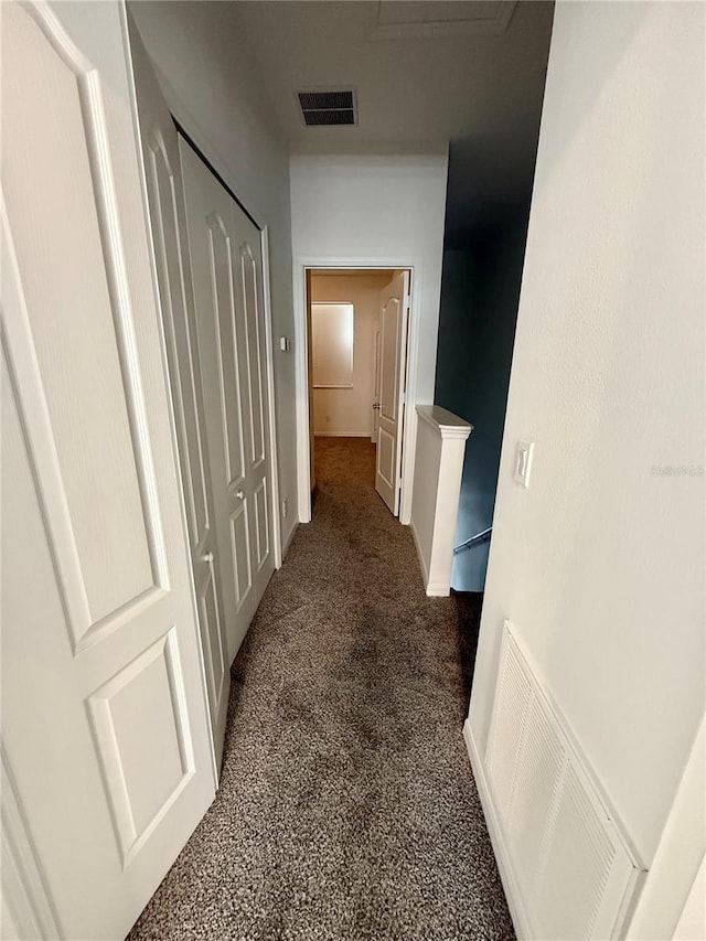 hall with carpet and an upstairs landing