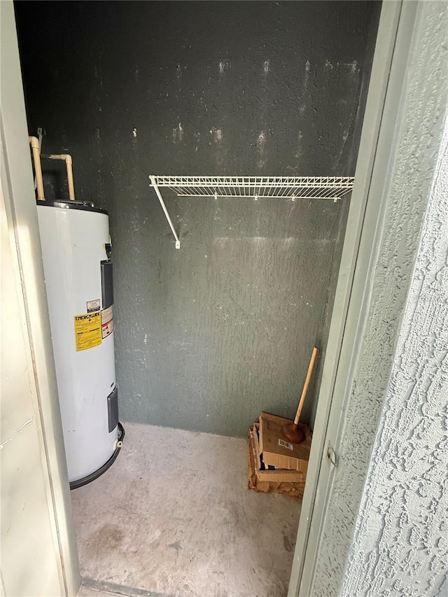utility room featuring water heater