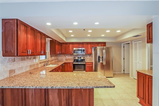 2006 Sycamore Ln, Plant City, FL 33563 - kitchen featuring appliances with stainless steel finishes, a sink, tasteful backsplash, baseboards, and light stone countertops