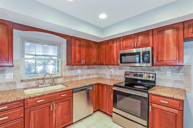 2006 Sycamore Ln, Plant City, FL 33563 - kitchen featuring appliances with stainless steel finishes, a sink, light stone countertops, and backsplash