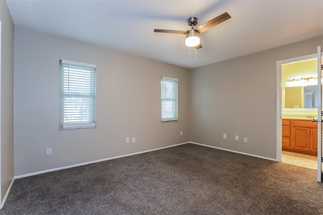 2006 Sycamore Ln, Plant City, FL 33563 - unfurnished bedroom with light colored carpet, baseboards, connected bathroom, and ceiling fan