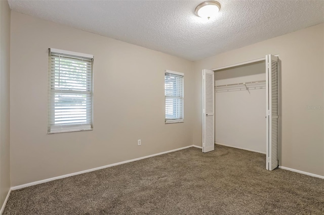 2006 Sycamore Ln, Plant City, FL 33563 - unfurnished bedroom with carpet, a textured ceiling, a closet, and baseboards