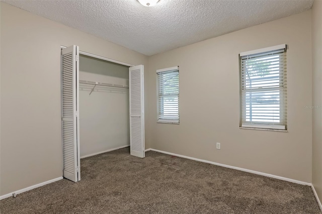 2006 Sycamore Ln, Plant City, FL 33563 - unfurnished bedroom featuring carpet, multiple windows, a closet, a textured ceiling, and baseboards