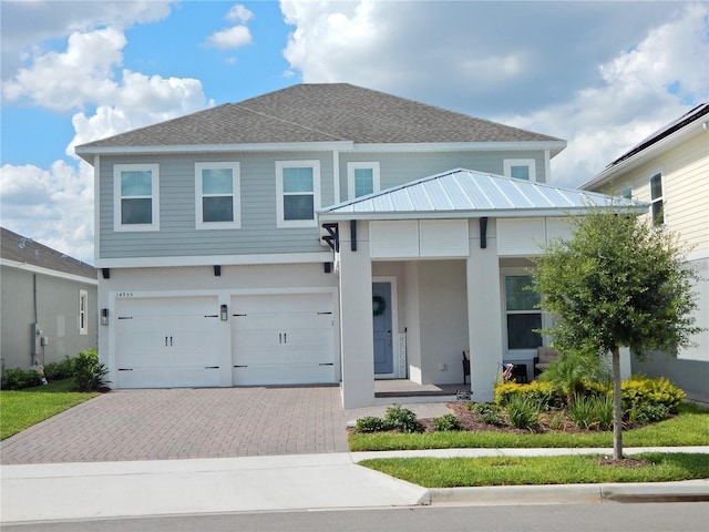 view of front of house with an attached garage, a porch, decorative driveway, and stucco siding