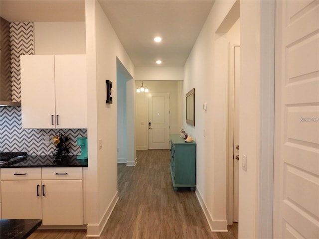 hall with baseboards, dark wood-style flooring, and recessed lighting