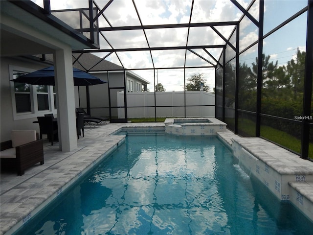 view of pool with a patio, a lanai, and a pool with connected hot tub