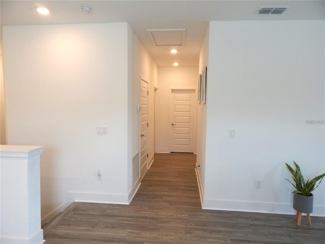 hallway with wood finished floors, baseboards, and recessed lighting