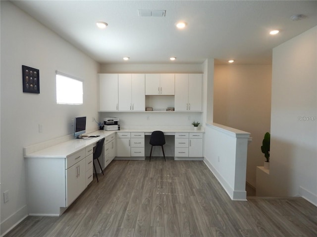 kitchen featuring wood finished floors, open shelves, white cabinetry, light countertops, and recessed lighting